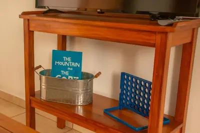 a book sitting in a pot on a shelf at Cozy coworking Casa Alma near Lake Arenal, 2 bedroom 1 office, fiber optic, pet friendly in Nuevo Arenal