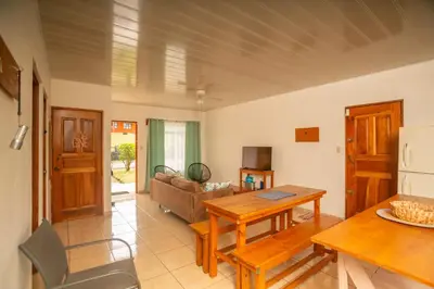 a living room with a table and a couch at Cozy coworking Casa Alma near Lake Arenal, 2 bedroom 1 office, fiber optic, pet friendly in Nuevo Arenal