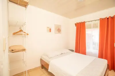 a bedroom with a bed and a glass shower at Cozy coworking Casa Alma near Lake Arenal, 2 bedroom 1 office, fiber optic, pet friendly in Nuevo Arenal