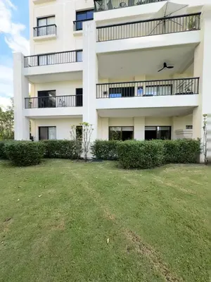 an apartment building with a yard in front of it at Amaluc zac in Jacó