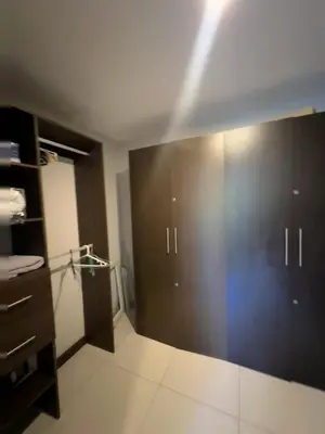 a bathroom with a large brown door in a room at Amaluc zac in Jacó