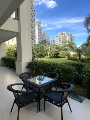 a table and chairs on a patio with a view of a yard at Amaluc zac in Jacó