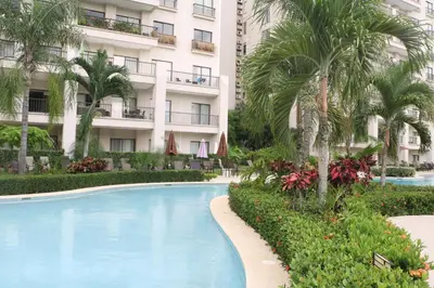 a swimming pool in front of a building at Amaluc zac in Jacó