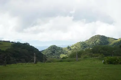 a green field with mountains in the background at Campo Azul #2 - Monteverde in Monteverde Costa Rica