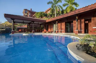 a large swimming pool in front of a building at Terrace 2BR Condo - Bougainvillea - Reserva Conchal Golf Resort in Playa Conchal