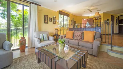 a living room with a couch and a table at Terrace 2BR Condo - Bougainvillea - Reserva Conchal Golf Resort in Playa Conchal
