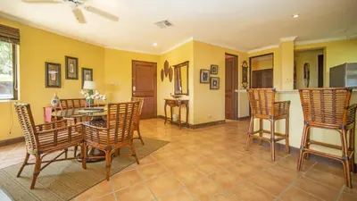 a dining room with a table and chairs at Terrace 2BR Condo - Bougainvillea - Reserva Conchal Golf Resort in Playa Conchal