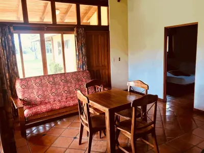a living room with a table and a couch at Nandel Beach Resort in La Cruz