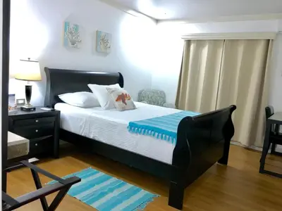 a bedroom with a bed and a chair in it at Hotel Zima in San Isidro
