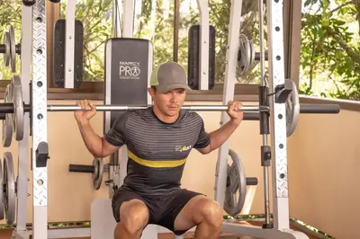 a man is doing squats in a gym at Hotel Zima in San Isidro