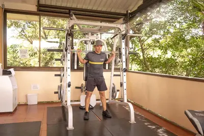 a man on a gym machine at Hotel Zima in San Isidro