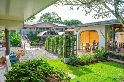 a backyard of a house with a garden at Hotel Zima in San Isidro