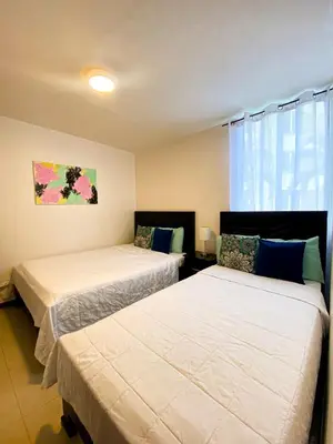 a bedroom with two beds and a window at Costa Linda 6-08 in Jacó