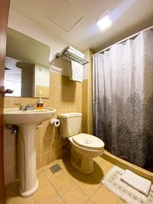 a bathroom with a toilet and a sink and a shower at Costa Linda 6-08 in Jacó