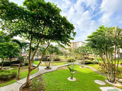 a park with trees and grass and buildings at Costa Linda 6-08 in Jacó