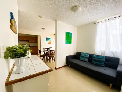 a living room with a couch and a table at Costa Linda 6-08 in Jacó