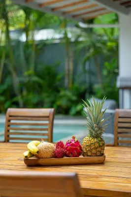 a plate of fruit on a wooden table at Peace Villa Santa Teresa - Walking distance to the beach in Santa Teresa Beach