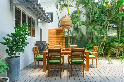 a wooden table and chairs on a deck at Peace Villa Santa Teresa - Walking distance to the beach in Santa Teresa Beach