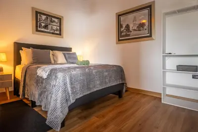 a bedroom with a bed with a gray comforter at BUDDA HOME in Tortuguero