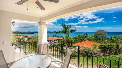 a balcony with a view of the ocean at Elegant Oceanview Condo with Spacious Open-Concept Floor Plan and Inviting Beach Design in Playa Flamingo