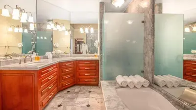 a bathroom with two sinks and a large mirror at Chic Condo with a Stylish Coastal Design in an Exclusive Condo Community with Direct Beach Access in Playa Flamingo