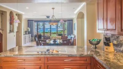a kitchen with a sink and a living room at Chic Condo with a Stylish Coastal Design in an Exclusive Condo Community with Direct Beach Access in Playa Flamingo