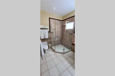 a bathroom with a shower and a toilet at Jazmin Del Sol steps away from Playa Potrero !! in Potrero