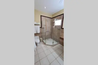 a bathroom with a shower and a toilet at Jazmin Del Sol steps away from Playa Potrero !! in Potrero