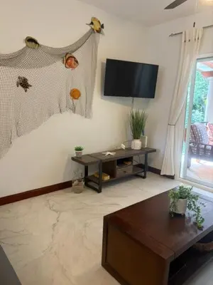 a living room with a flat screen tv on the wall at Jazmin Del Sol steps away from Playa Potrero !! in Potrero