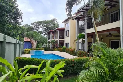 a house with a swimming pool in a yard at Jazmin Del Sol steps away from Playa Potrero !! in Potrero