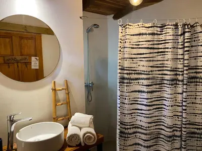 a bathroom with a shower curtain and a sink at Ginger Studio in Santa Teresa Beach