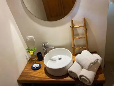 a bathroom with a white sink and a mirror at Ginger Studio in Santa Teresa Beach