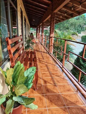 a porch of a house with plants on it at El Nido Lodge in Monteverde Costa Rica