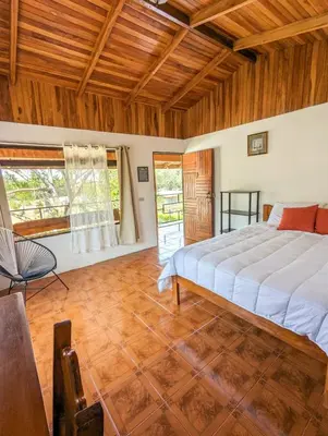 a bedroom with a bed and a wooden ceiling at El Nido Lodge in Monteverde Costa Rica