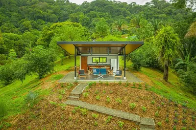a house in the middle of a hill with a living room at The Sutton - Boutique Jungle Experience - Walk to Envision Festival in Uvita