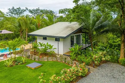 a small house with a garden and a pool at The Sutton - Boutique Jungle Experience - Walk to Envision Festival in Uvita