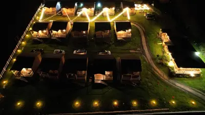 an aerial view of a building at night with lights at Hotel Cabañas y Mirador Secret Garden CR in Cartago