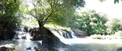 a painting of a waterfall next to a river at Nasu Lodge in La Cruz