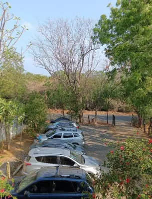 a row of cars parked in a parking lot at Nasu Lodge in La Cruz