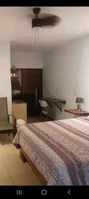 a bedroom with a bed and a ceiling fan at Hotel la Cueva Limon in Puerto Limón