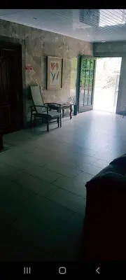 a room with two chairs and a bench in a building at Hotel la Cueva Limon in Puerto Limón