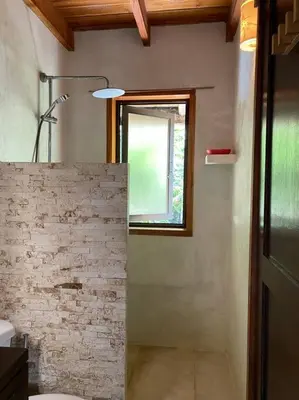 a bathroom with a sink and a window and a toilet at Tropical - Airy, open plan apartment in heart of Santa Teresa in Santa Teresa Beach