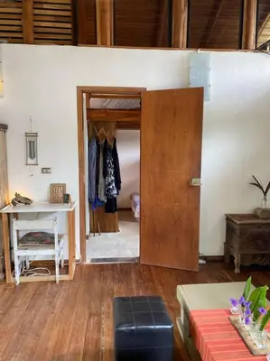 a room with a door and a table and a desk at Tropical - Airy, open plan apartment in heart of Santa Teresa in Santa Teresa Beach