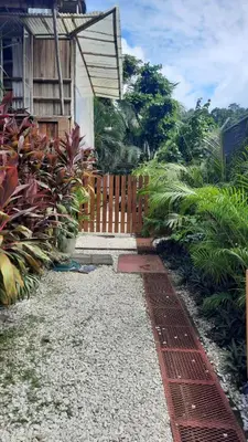 a pathway leading to a house with a wooden fence at Tropical - Airy, open plan apartment in heart of Santa Teresa in Santa Teresa Beach