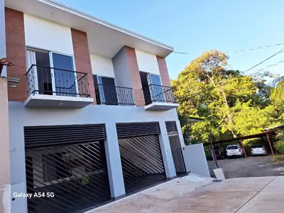 a house with two garage doors and two balconies at Victoria House in San Isidro