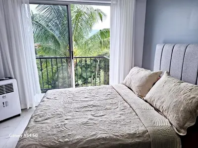a bedroom with a bed and a large window at Casa Victoria Alojamiento in San Isidro