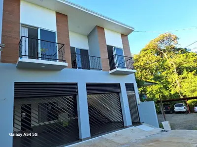 a house with two garage doors and two balconies at Casa Victoria Alojamiento in San Isidro