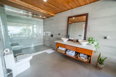 a bathroom with two sinks and a mirror at Flower’s Paradise Monteverde in Monteverde Costa Rica