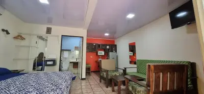 a bedroom with a bed and a table and chairs at Mangaby Playa Hermosa in Playa Hermosa