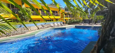 a swimming pool in front of a hotel at Mangaby Playa Hermosa in Playa Hermosa